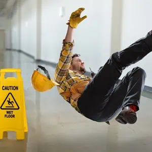 Man slipping on wet floor, symbolizing slip & fall accident - Mannis Law